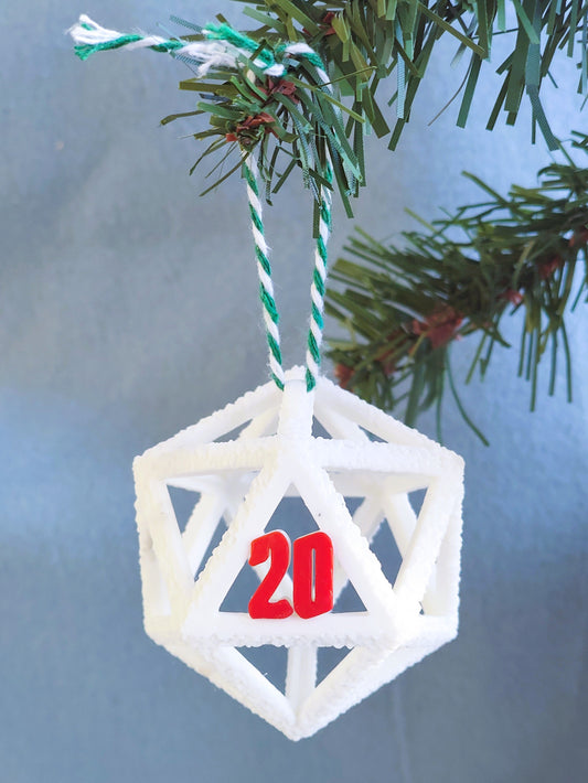 Geometric Christmas ornament with number '20' hanging on a tree branch.